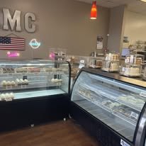 Inside Kiss Me Cakes bakery in Hope Mills, NC showing the dessert display cases